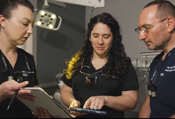 three doctors discussing in a dental office