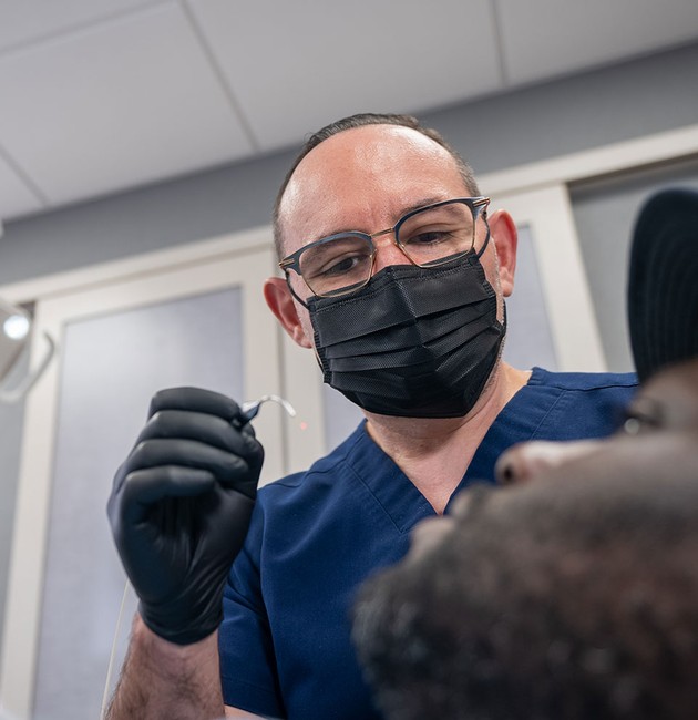 doctor treating patient in dental office